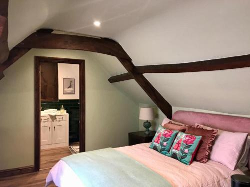 a bedroom with a large bed in a attic at Dunster Luxe Nook in Dunster