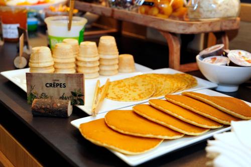 a table topped with cheese and crackers on a table at ibis Styles Paris Gare De Lyon TGV in Paris