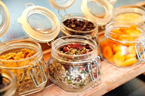 a table with jars filled with different types of food at ibis Styles Paris Gare De Lyon TGV in Paris