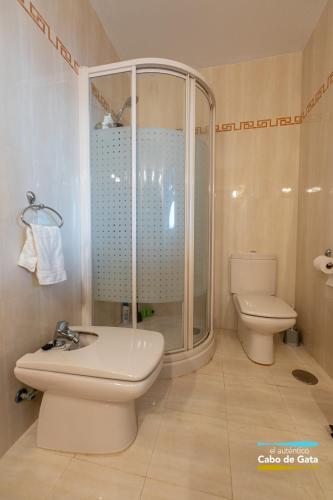 a bathroom with a shower and a toilet and a sink at CASA VELA BLANCA in San José