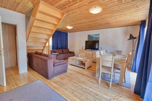 a living room with a couch and a table at Jacobs Resort House Kranjska Gora in Kranjska Gora