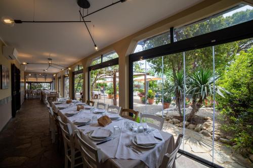 a long table in a restaurant with large windows at Agriturismo Santo Stefano in Casalbordino