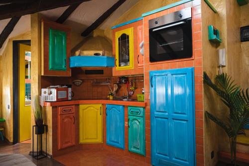 a kitchen with colorful cabinets and a play house at Sky with sky view in Poreč