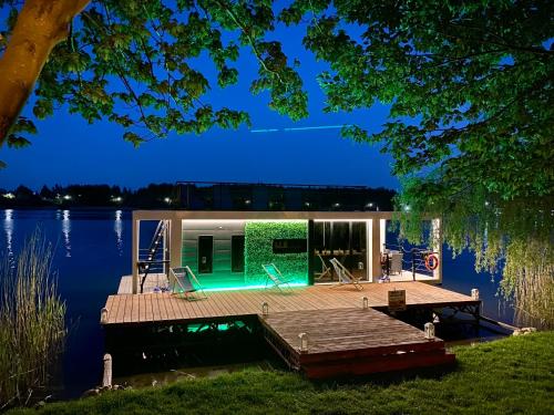 a house on the water with a dock at AquaHouse Zamkowe in Wąbrzeźno