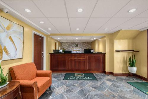 a waiting room with a chair and a desk at Hibiscus Inn & Suites in Absecon