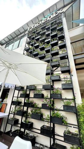 a building with potted plants on the side of it at PHOENIX MINH CHÂU HOTEL in Quang Ninh