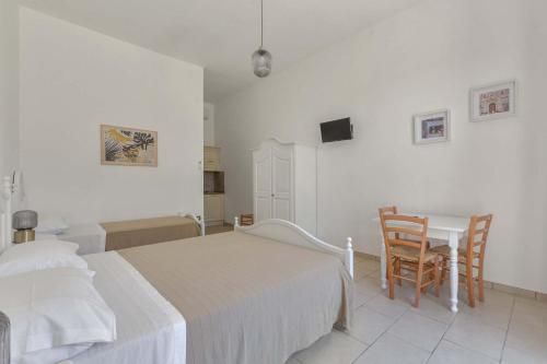 a bedroom with a bed and a desk and a table at Villa La Paiara by Perle di Puglia in Borgagne