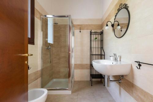 a bathroom with a sink and a shower at Villa La Paiara by Perle di Puglia in Borgagne