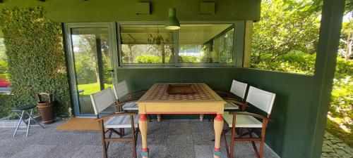 a table and chairs sitting on a patio at Casas da Tapada Briteiros Casa dos Ficos in Guimarães