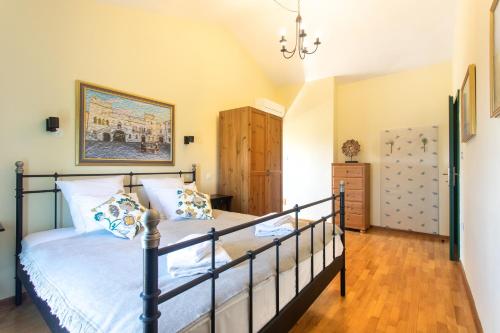 a bedroom with a bed and a painting on the wall at VILLA GOLD ISTRA in Portorož