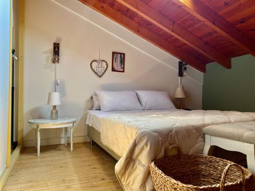 a bedroom with a large bed and a table at Luxury Family House with Backyard in Mantoúkion