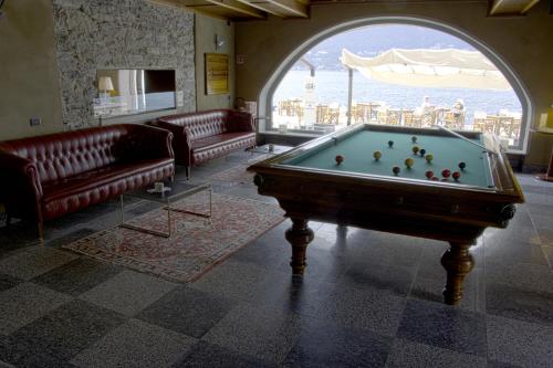 a living room filled with furniture and a pool at Hotel San Rocco in Orta San Giulio