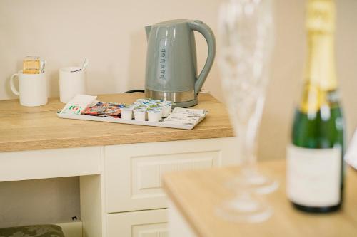 a blender on a counter next to a bottle of wine at The Maynard in Scarborough