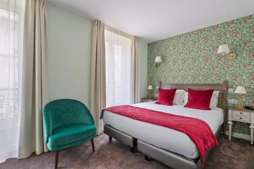 a bedroom with a bed and a green chair at H&ocirc;tel de S&egrave;vres in Paris