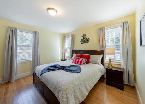 a bedroom with a bed and two windows at 284 - 5BR Boston - Peaceful House near England Aqua in Quincy