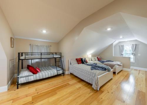 a bedroom with two bunk beds in a attic at 284-Newbuilt Entire House with free huge parking lot in Quincy