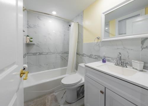 a white bathroom with a toilet and a sink at 284-Newbuilt Entire House with free huge parking lot in Quincy