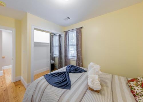 a bedroom with a bed with blue sheets and a window at 284 - 5BR Boston - Peaceful House near England Aqua in Quincy