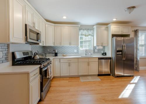 a kitchen with white cabinets and stainless steel appliances at 284 - 5BR Boston - Peaceful House near England Aqua in Quincy