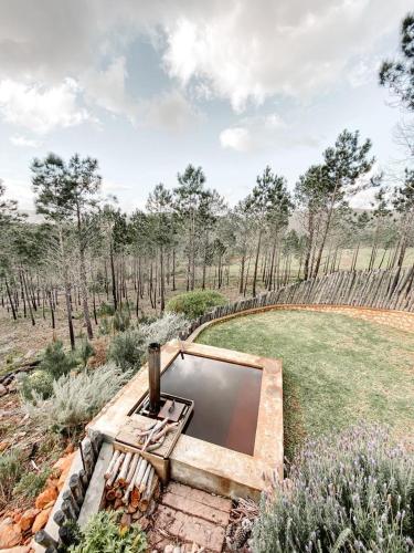 an outdoor pool in the middle of a garden at Krakeelpoort Herberg in Botrivier