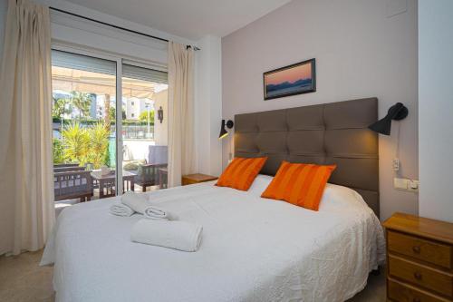 a bedroom with a large white bed with orange pillows at Estrella 2 BA Spaniahome in Albir