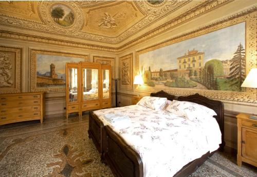 a bedroom with a bed and a painting on the ceiling at Casa della Sofora in Bene Vagienna