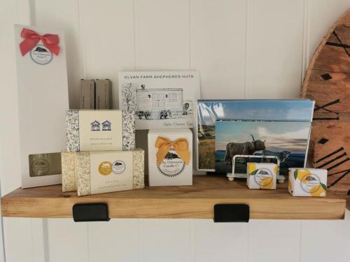 a shelf with a bunch of boxes on it at Elvan Farm Shepherd's Hut in Exeter