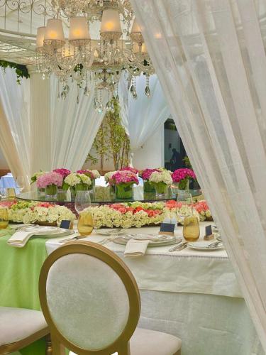 a long table with flowers on it with a chandelier at Hyatt Regency Casablanca in Casablanca