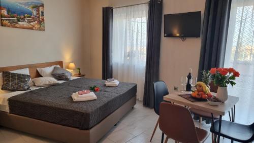 a bedroom with a bed and a table with chairs at Secret Garden Hotel in Maleme