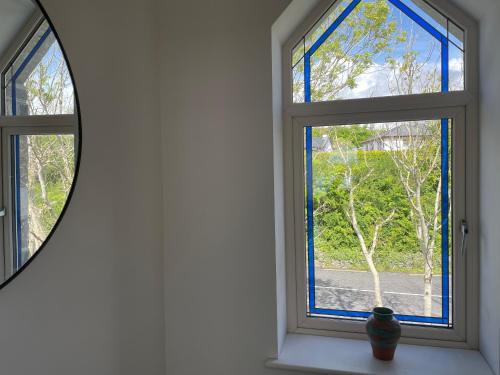 a window in a room with a mirror at Lough Key Luxury Riverfront Apartment in Cootehall