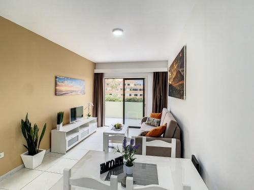 a living room with a couch and a table at Sunset Lover Playa Jardin in Puerto de la Cruz