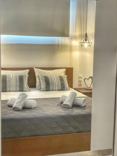 a bedroom with a bed with pillows on it at Coastline of Paradise in Paránimfoi
