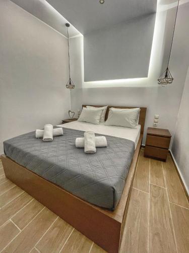 a bedroom with a bed with two towels on it at Coastline of Paradise in Paránimfoi