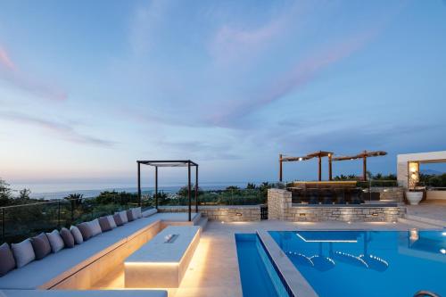 an outdoor swimming pool with a view of the ocean at Alpha Estate & Spa in Rethymno Town