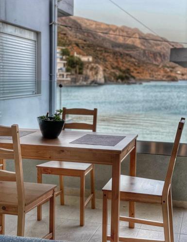 a table and chairs with a view of the water at Coastline of Paradise in Paránimfoi