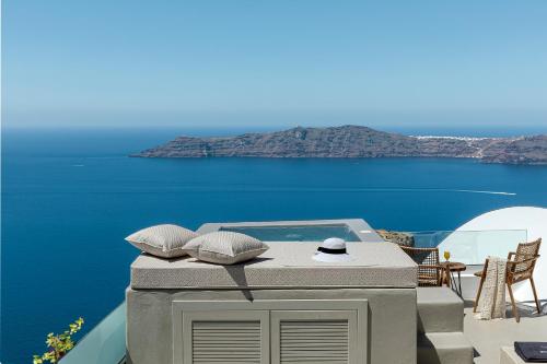 a table with pillows sitting on top at Kaleidoscope Imerovigli Suites in Imerovigli