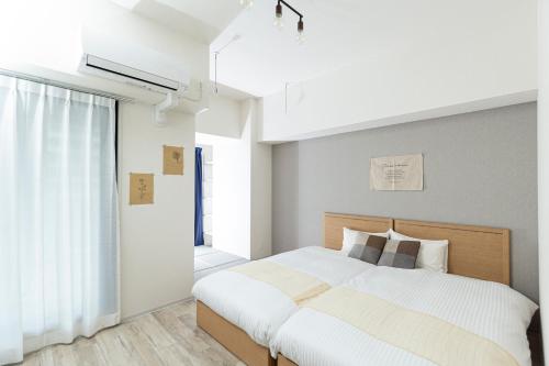 Säng eller sängar i ett rum på Minn Umeda-East
