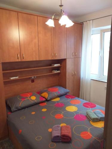 a bedroom with a bed with a flower pattern on it at Kuća za odmor Mery in Crikvenica