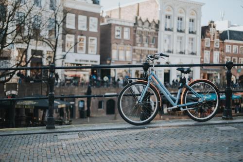 a bike parked next to a rail on a street at Stayokay Hostel Utrecht Centrum in Utrecht