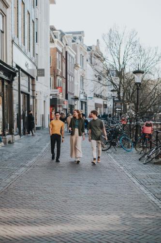 a group of people walking down a street at Stayokay Hostel Utrecht Centrum in Utrecht