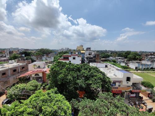 an overhead view of a city with buildings and trees at Ashiyana Rest House in Deoghar