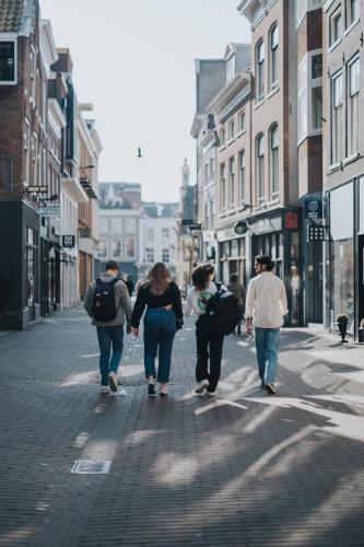 a group of people walking down a city street at Stayokay Hostel Haarlem in Haarlem