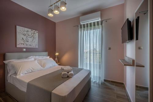 a bedroom with a bed with two towels on it at ''Aeolos'' Luxury Villa in Preveza