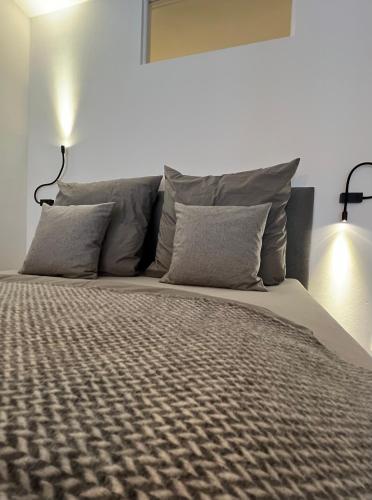 a bedroom with a large bed with two pillows at Apartmenthaus Stade Schwingewiesen Apartment 2 in Stade