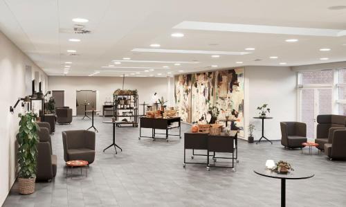 a store with chairs and tables in a room at Comwell Middelfart in Middelfart