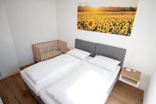 two beds in a room with a painting on the wall at Family XL - Bungalows in Lutzmannsburg