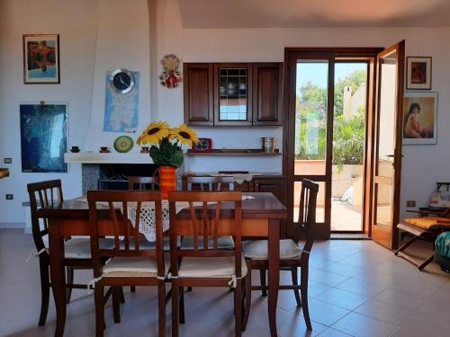 a kitchen and dining room with a table and chairs at Il giglio vista mare num iun Q6084 in Funtana Meiga