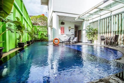 a swimming pool in the middle of a building at Grand Tjokro Yogyakarta in Yogyakarta