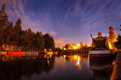 a boat is docked in the water at night at The Mooring Post in Gloucester