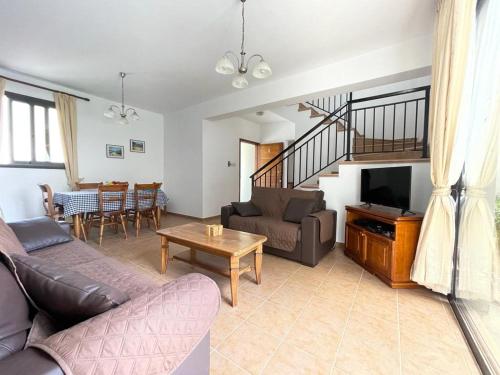 a living room with a couch and a table at Spacious 3 bedroom villa private pool in Paphos City